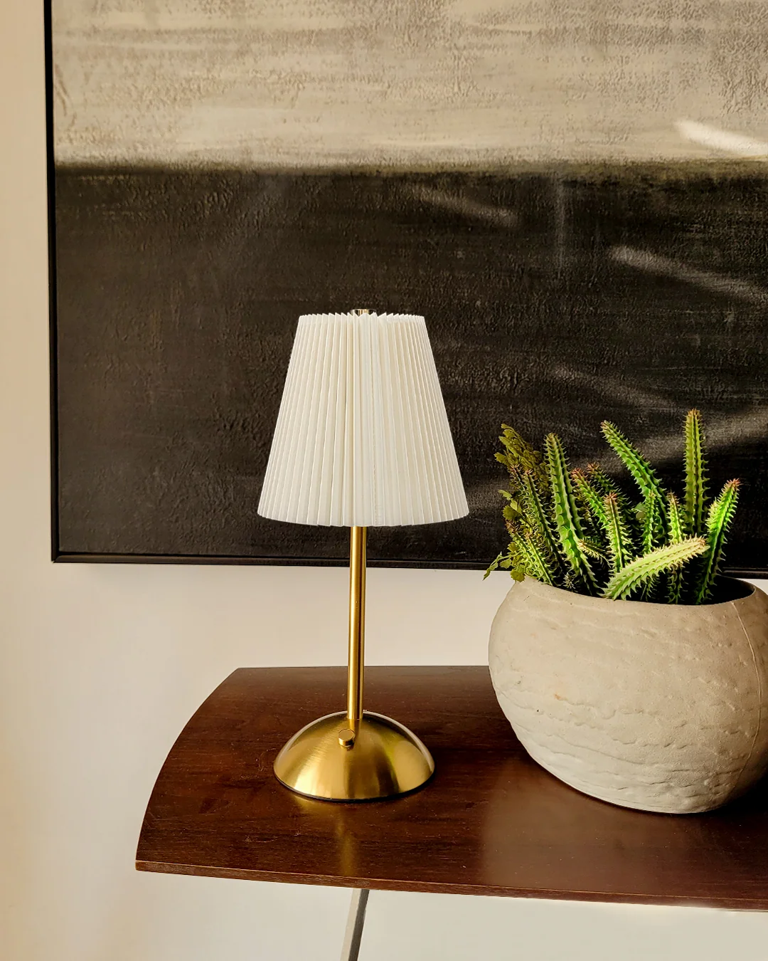 Elixir gold touch sensor lamp with signature pleated fabric shade, emitting a 3000K warm glow for luxury bedside ambiance.