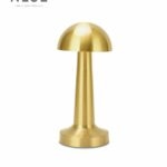 Neje Lighting | Domea : Signature Cordless Elegance & Precision Dimming Domea gold touch sensor lamp emitting a warm 3000K ambient glow on a minimalist textured surface, ideal for luxury Indian bedrooms.