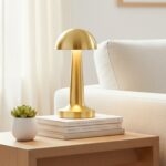 Neje Lighting | Domea Series: Signature Cordless Elegance & Precision Dimming Domea gold touch sensor lamp emitting a warm 3000K ambient glow on a minimalist textured surface, ideal for luxury Indian bedrooms.