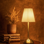 Elixir gold touch sensor lamp with signature pleated fabric shade, emitting a 3000K warm glow for luxury bedside ambiance.
